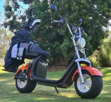 Harley-inspired electric golf scooter with fat 10-inch tires and LED headlights for rugged course terrain