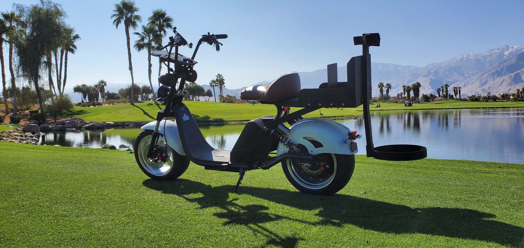 Dual hydraulic suspension on Harley-style golf scooter for smooth rides over rough terrain