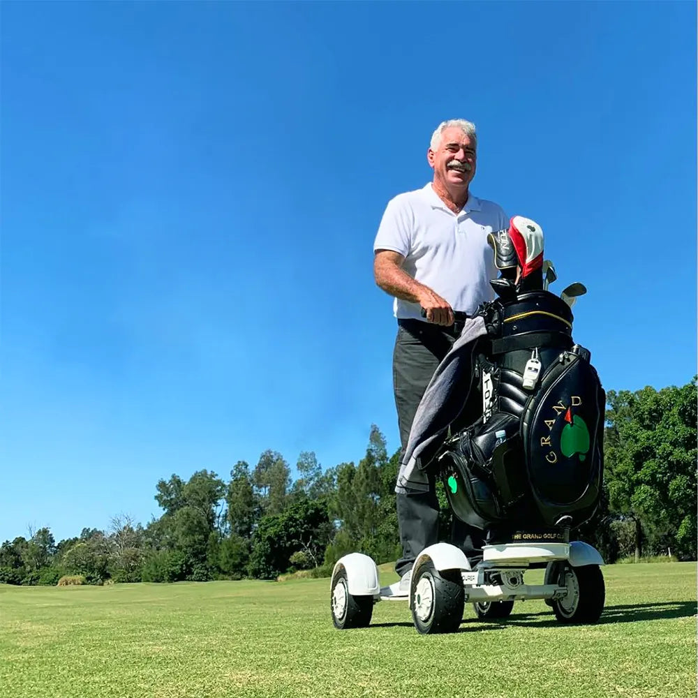 Electric golf scooter tackling bunker terrain with 10-inch tires and 20° climb capability