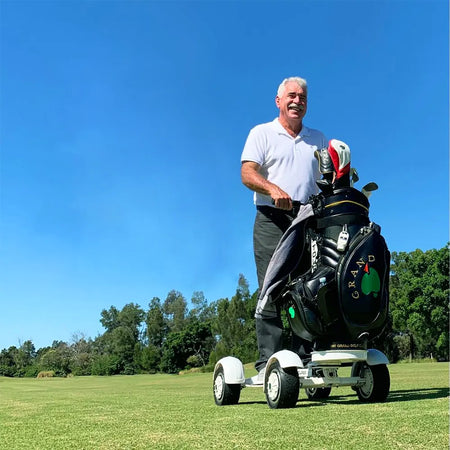 Electric golf scooter tackling bunker terrain with 10-inch tires and 20° climb capability