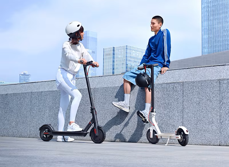 Front and rear suspension on electric scooter absorbing bumps for smooth rides on urban streets