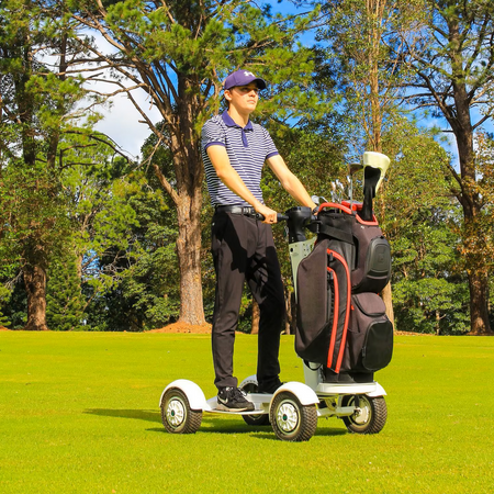 Dual 1000W motors powering electric golf scooter on grassy incline (20km/h max speed)